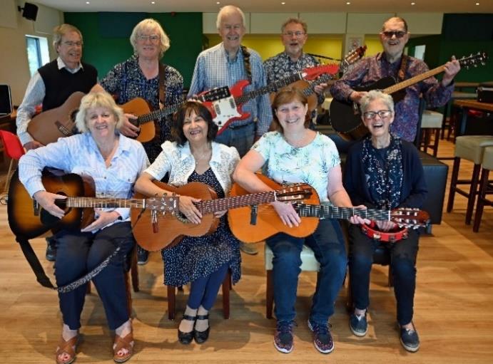 Photo of singing guitars group playing their instruments
